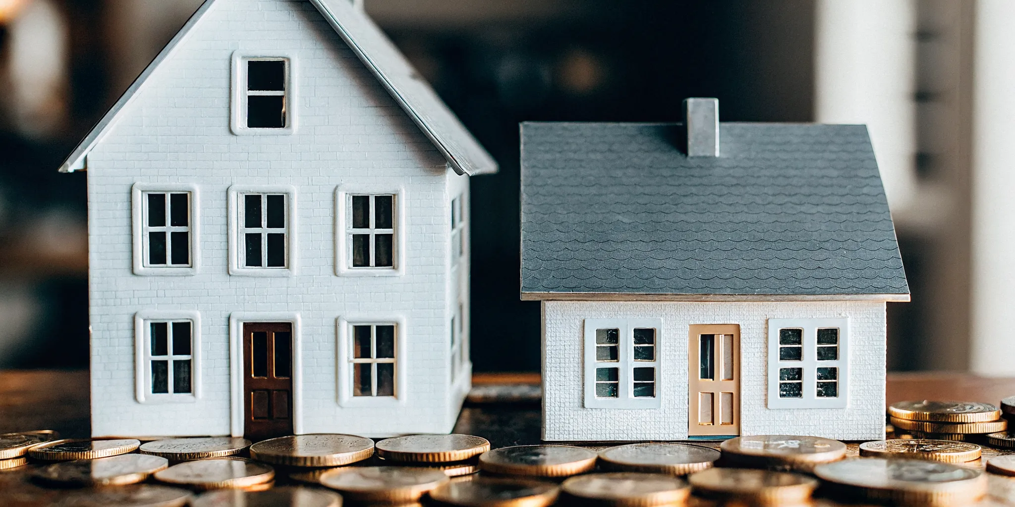 Two houses side by side labeled FHA and Conventional representing mortgage comparison