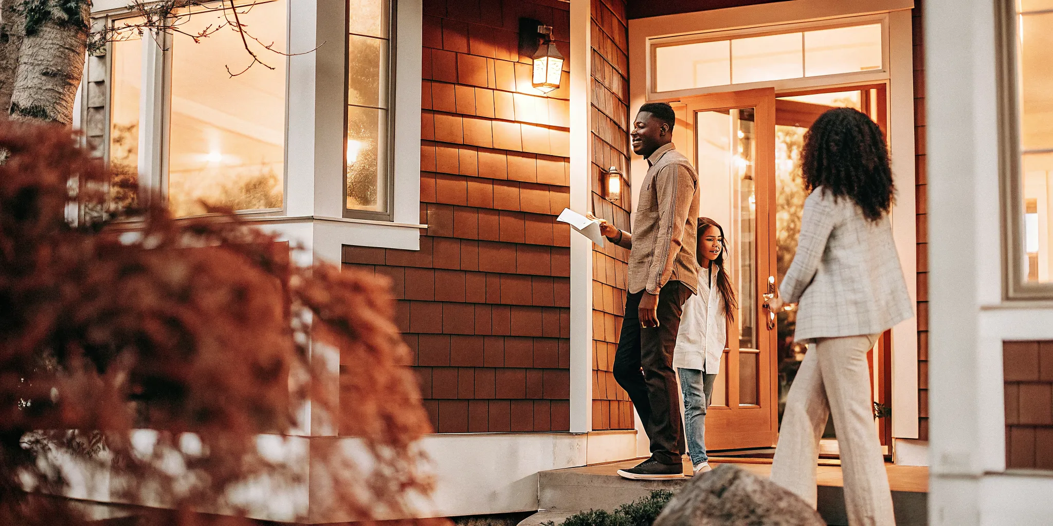 Modern home exterior with warm lighting representing homeownership opportunity