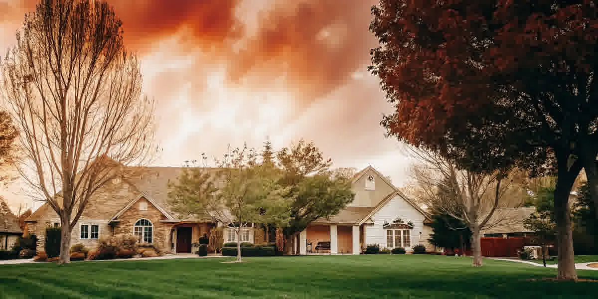 Suburban Texas home with green lawn at sunset, representing the dream of affordable homeownership